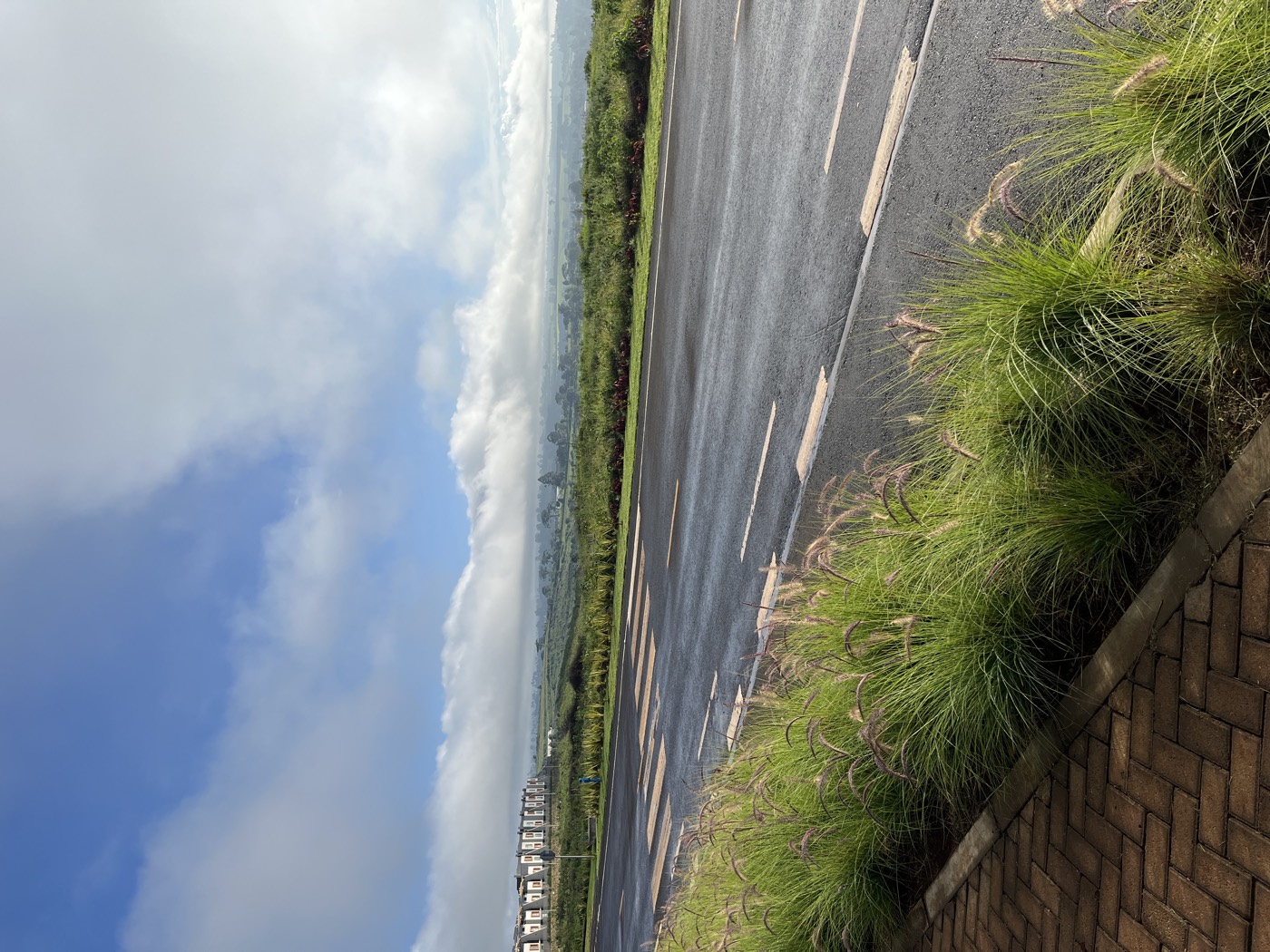 A wide open road under big highland skies